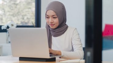 beautiful-asian-muslim-lady-casual-wear-working-using-laptop-modern-new-normal-office_7861-2975